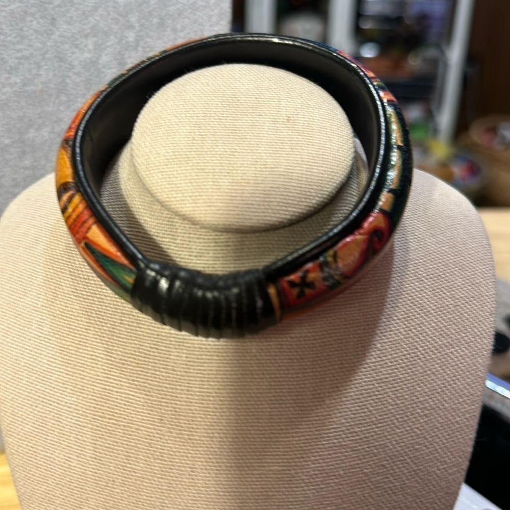 Gorgeous bracelet. Vintage It appears that it’s wrapped in leather at one end.